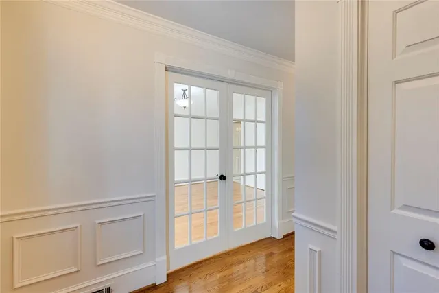 a view of an empty room with cabinet and floor to ceiling window