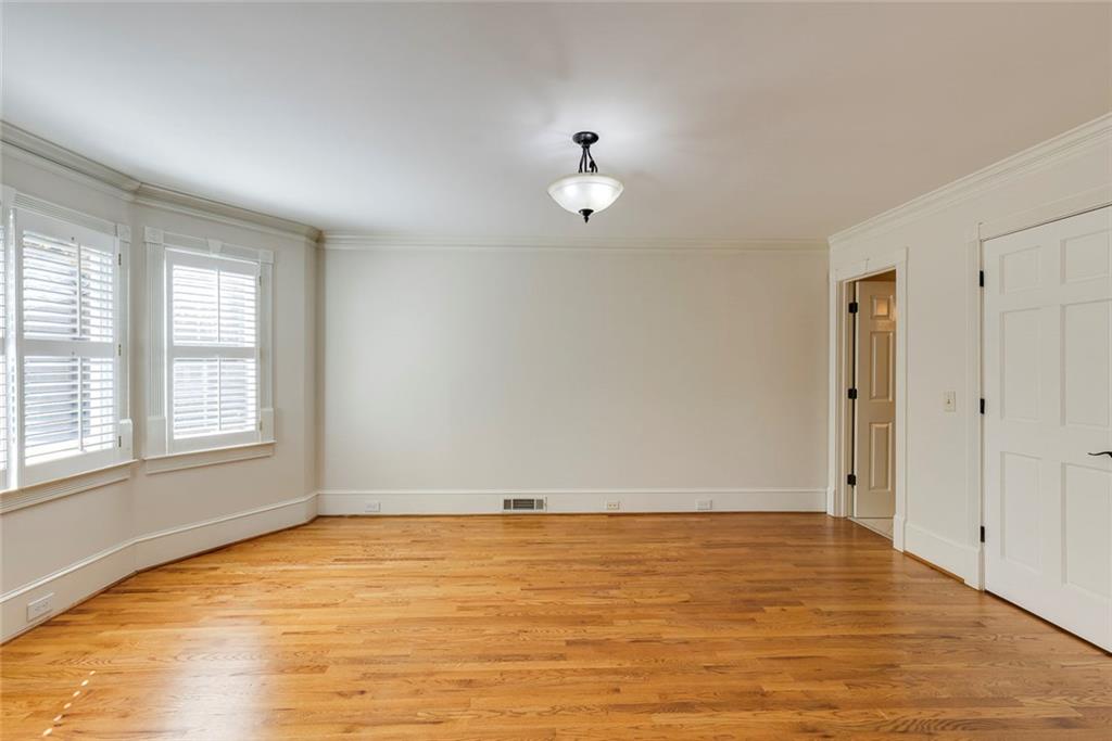 5377 Trentham Drive Dunwoody, GA 30338 - Photo 10 of 51 an empty room with wooden floor and windows
