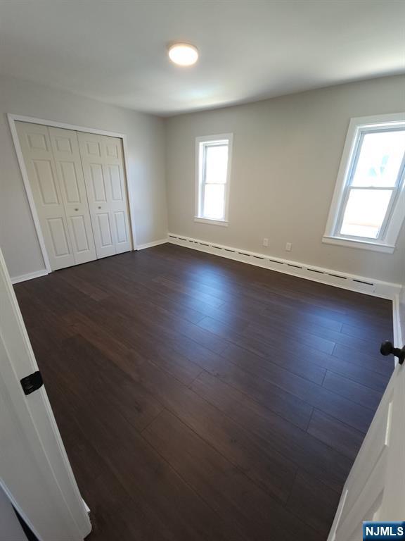21 Ave D, Unit 2 Lodi, NJ 07644 - Photo 4 of 7 an empty room with wooden floor and windows