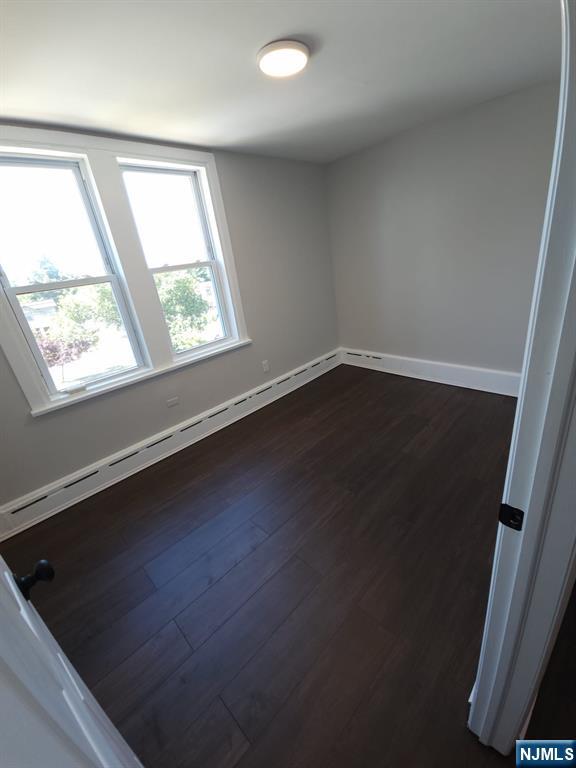 21 Ave D, Unit 2 Lodi, NJ 07644 - Photo 6 of 7 an empty room with wooden floor and windows