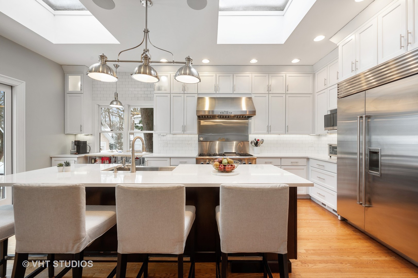 1031 Maple Avenue Evanston, IL 60202 - Photo 14 of 54 a kitchen with a dining table chairs cabinets and stainless steel appliances