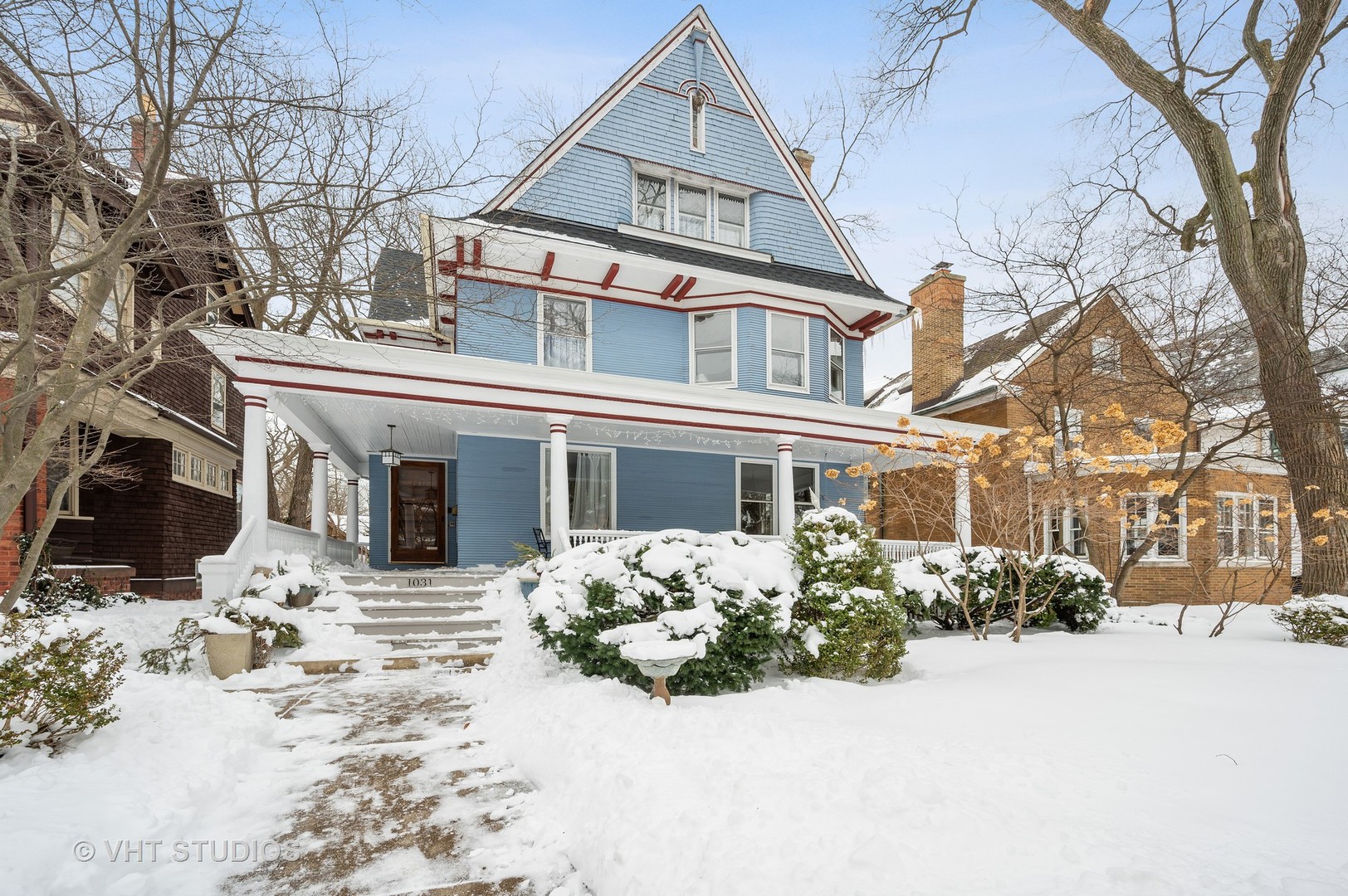 1031 Maple Avenue Evanston, IL 60202 - Photo 2 of 54 a front view of a house with a yard covered in snow