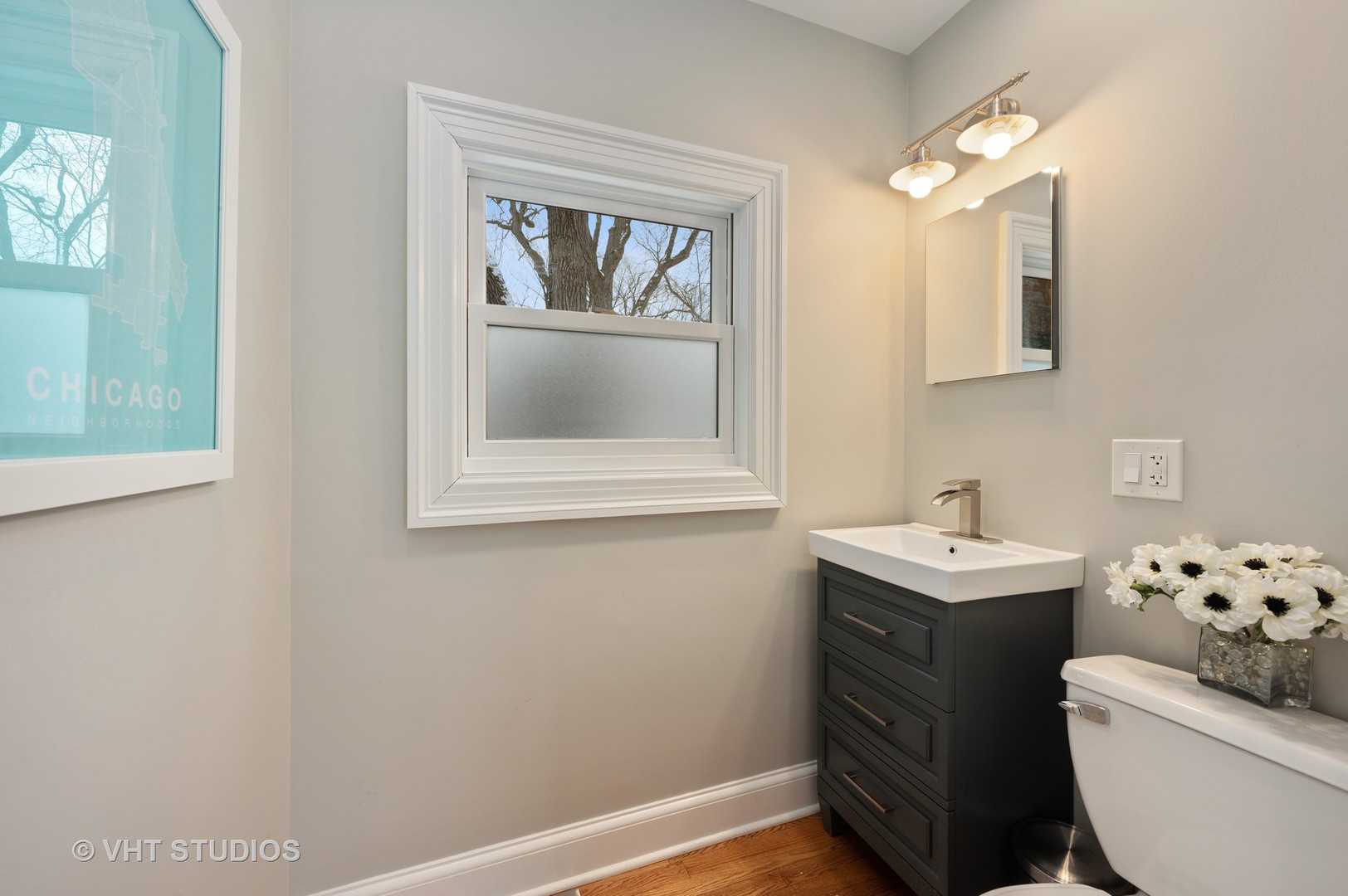 1031 Maple Avenue Evanston, IL 60202 - Photo 24 of 54 a bathroom with a toilet a sink and mirror