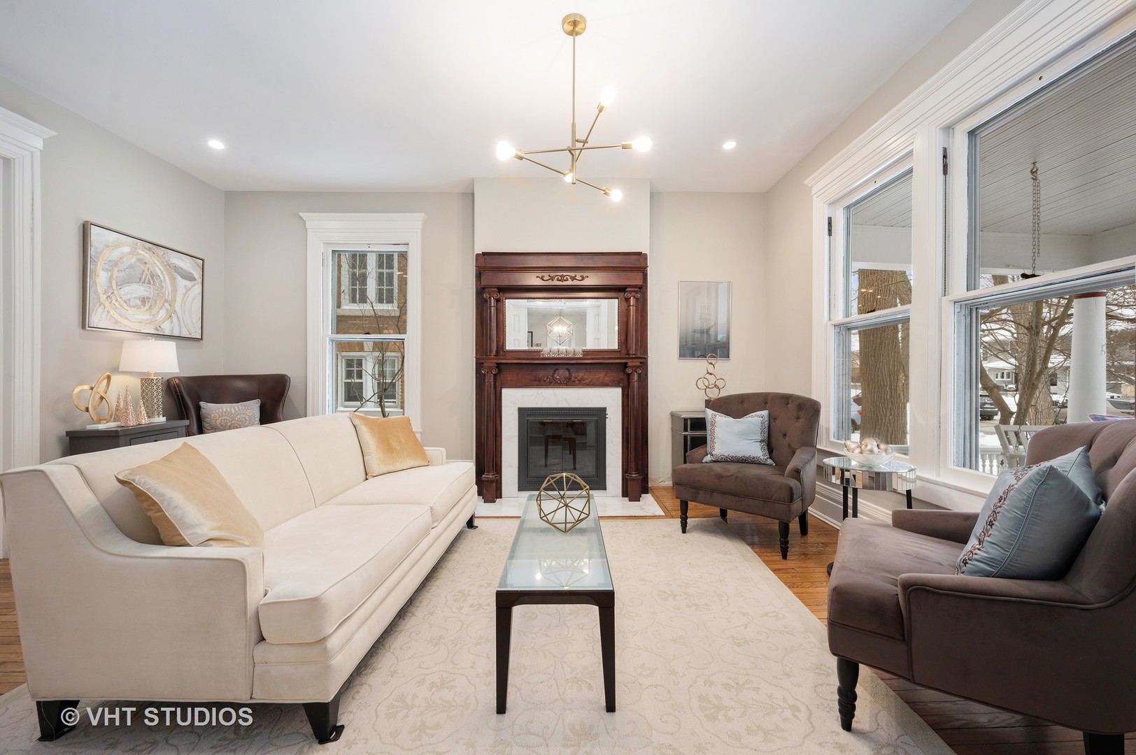 1031 Maple Avenue Evanston, IL 60202 - Photo 9 of 54 a living room with furniture a fireplace and a chandelier