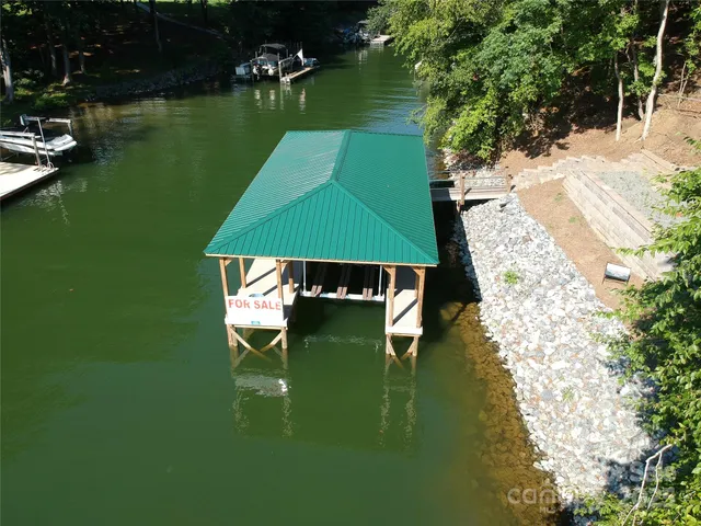 an aerial view of a house with a yard basket ball court and outdoor seating