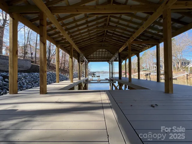 a view of a yard with wooden fence