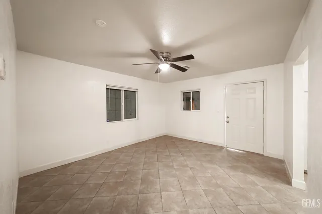 a view of an empty room with a ceiling fan