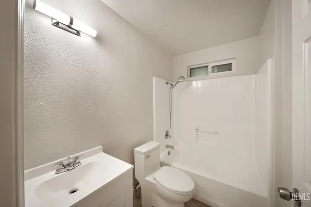 a bathroom with a sink mirror toilet and shower