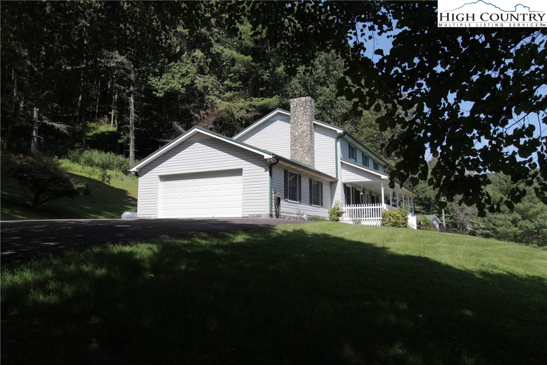 581 North Fork New River Road Lansing, NC 28643 - Photo 22 of 44 a front view of a house with a yard
