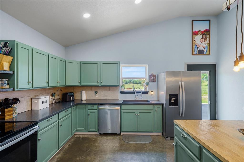 1026 VZ County Road Canton, TX 75103 - Photo 27 of 40 a kitchen with kitchen island a sink stove and refrigerator