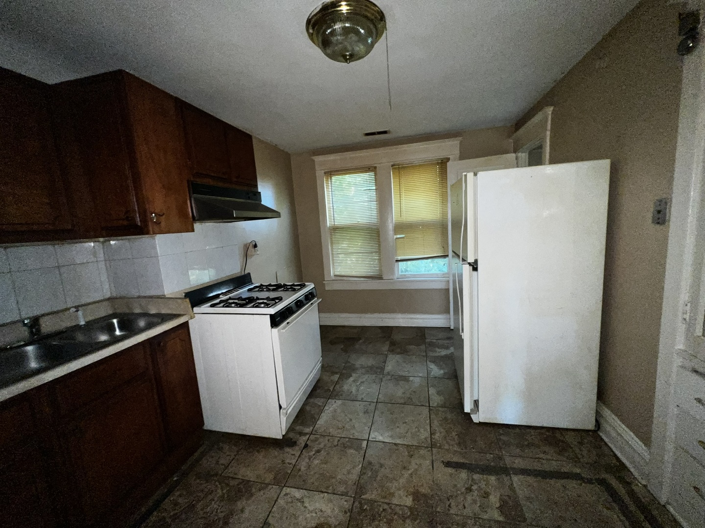 1511 Greenleaf Street Evanston, IL 60202 - Photo 11 of 37 a kitchen with a refrigerator and a stove top oven