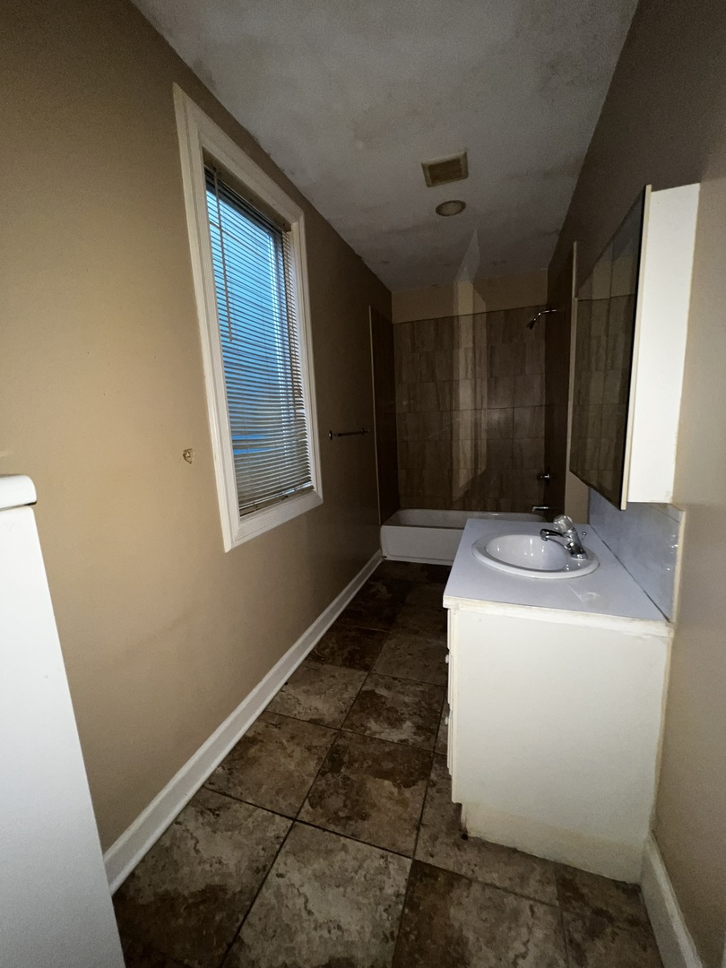 1511 Greenleaf Street Evanston, IL 60202 - Photo 14 of 37 a bathroom with a sink and a mirror