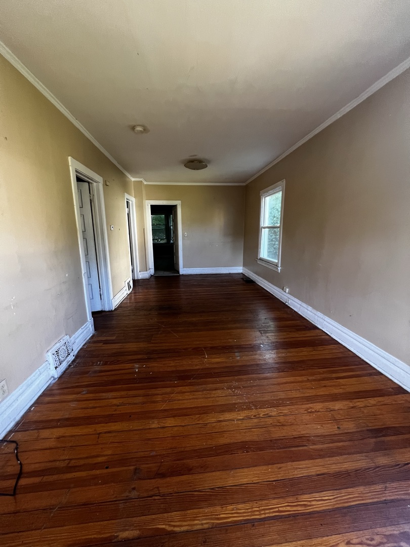1511 Greenleaf Street Evanston, IL 60202 - Photo 28 of 37 a view of an empty room with wooden floor and window