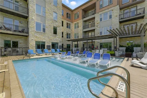 a view of a swimming pool with outdoor seating