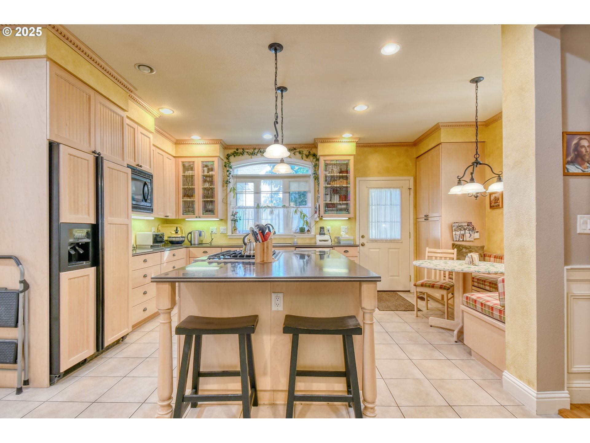 310 East Washington Street Athena, OR 97813 - Photo 12 of 45 a kitchen with stainless steel appliances kitchen island granite countertop a refrigerator a stove a kitchen island with chairs and wooden floor