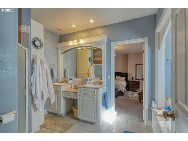 a bathroom with a sink mirror and a toilet