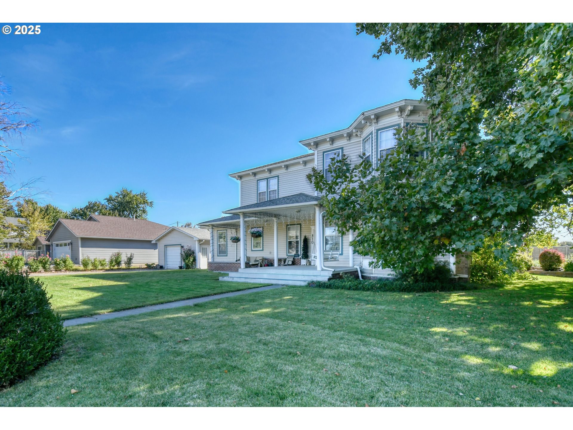 310 East Washington Street Athena, OR 97813 - Photo 2 of 45 a view of a house with a big yard and large trees