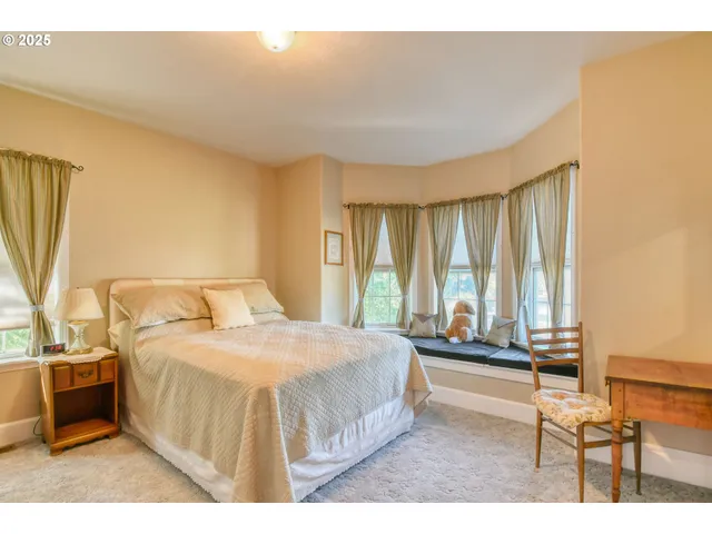 a spacious bedroom with a bed and a table