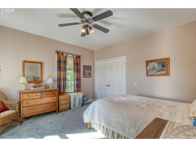 a spacious bedroom with a bed and a chandelier