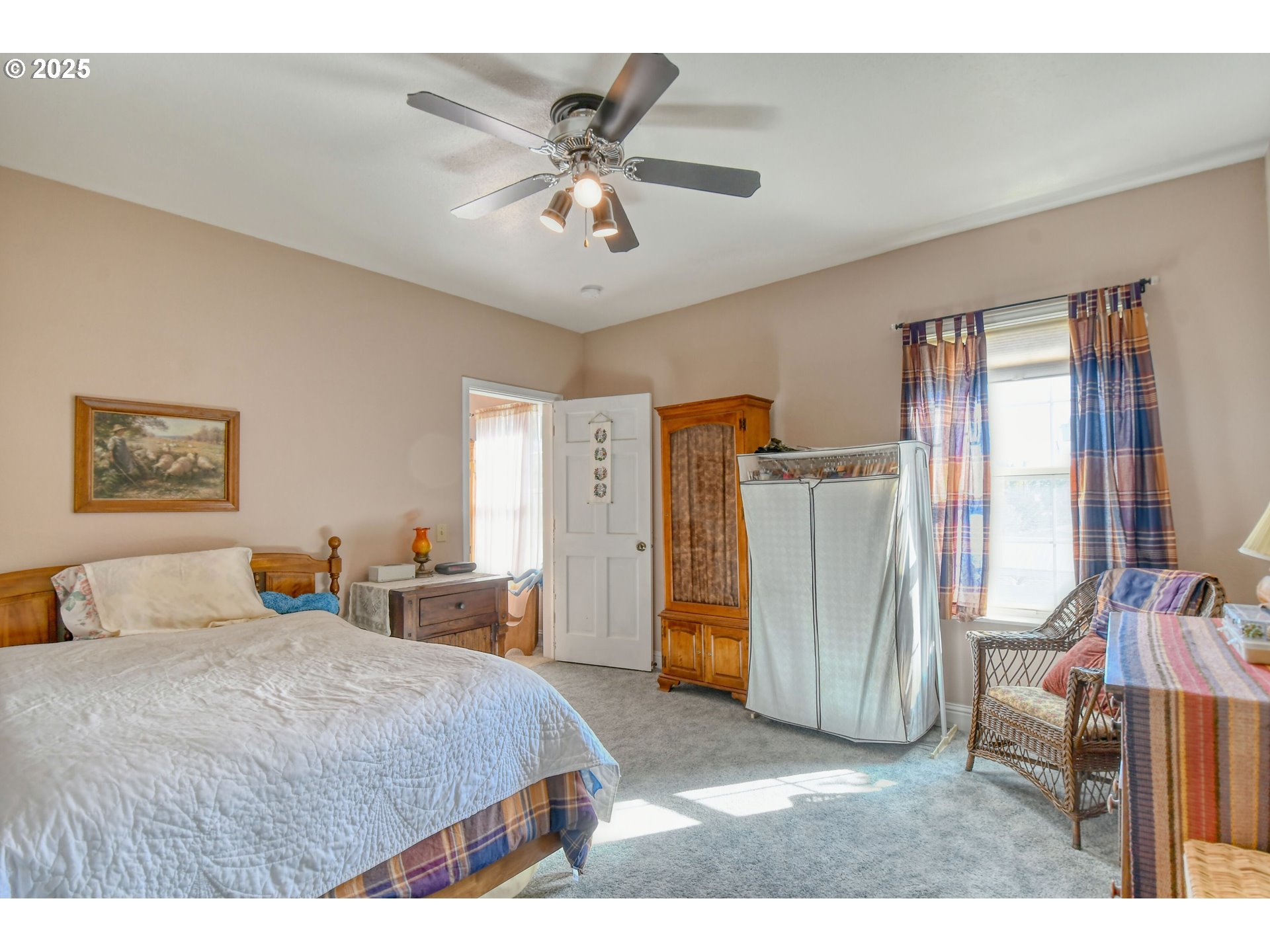 310 East Washington Street Athena, OR 97813 - Photo 25 of 45 a bedroom with a bed and a chandelier