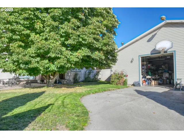 a view of a house with backyard and sitting area