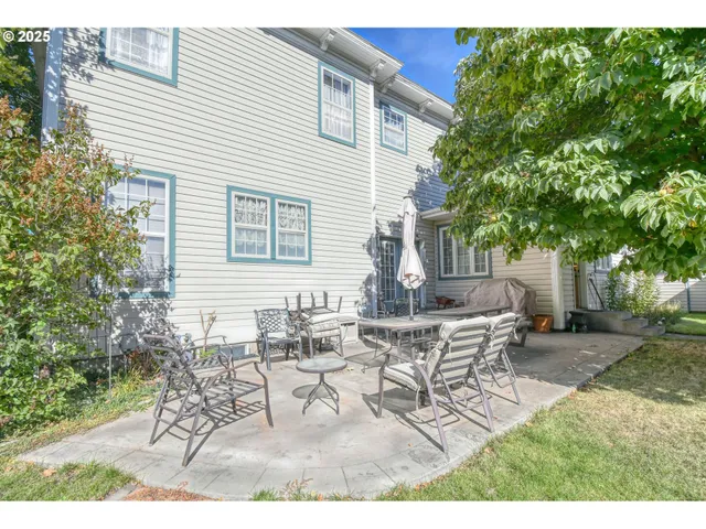 a view of a yard with furniture and a garden