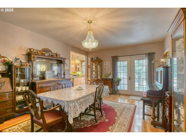 a dining room with furniture window and wooden floor