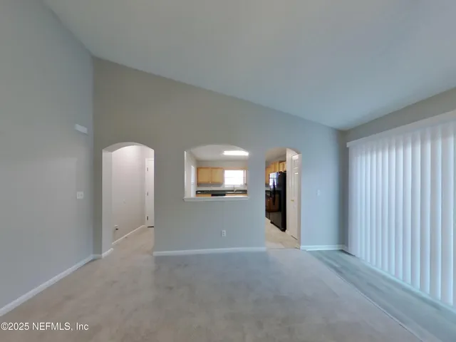 a view of a livingroom with wooden floor and windows