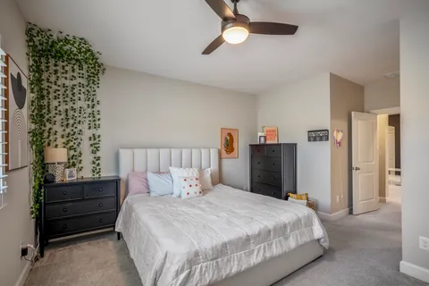 a bedroom with a bed and a chandelier