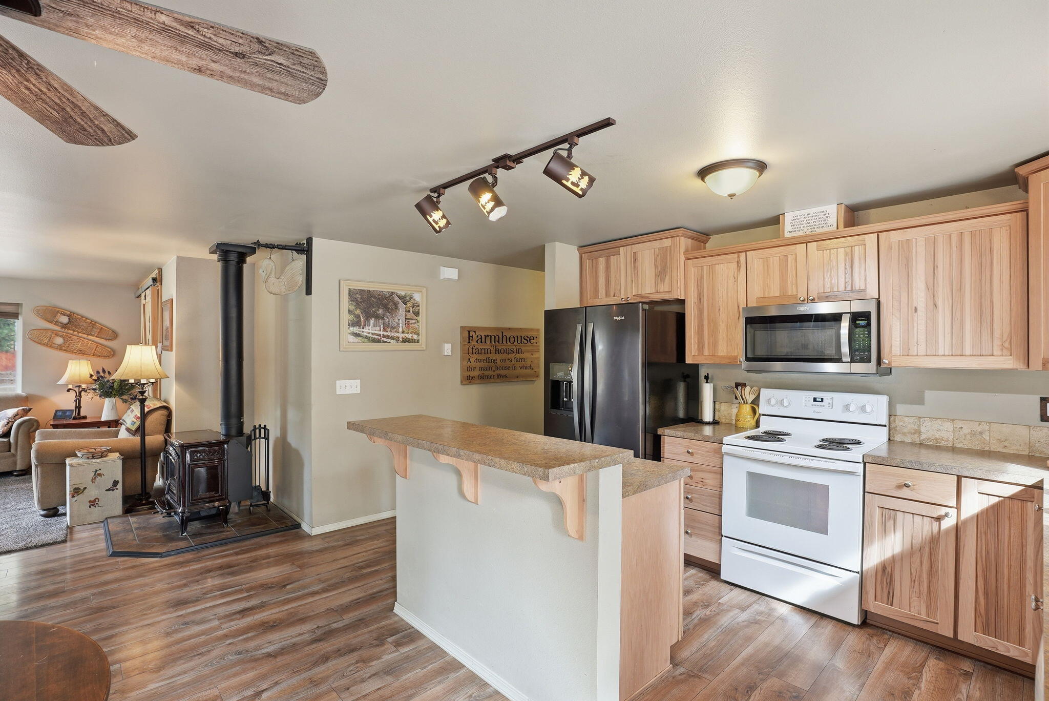 51432 Jory Road La Pine, OR 97739 - Photo 12 of 51 a kitchen with granite countertop a refrigerator a stove top oven a sink and dishwasher with wooden floor