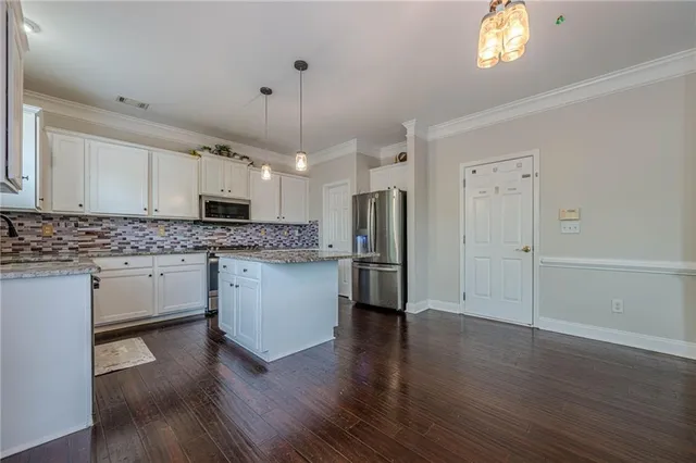 a kitchen with stainless steel appliances a refrigerator sink and cabinets