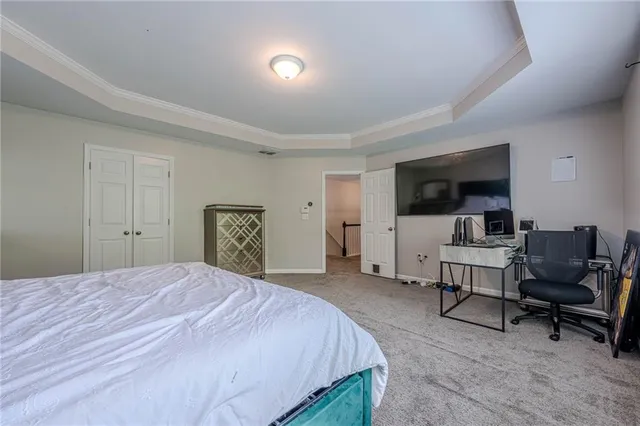 a spacious bathroom with a granite countertop sink mirror and bathtub