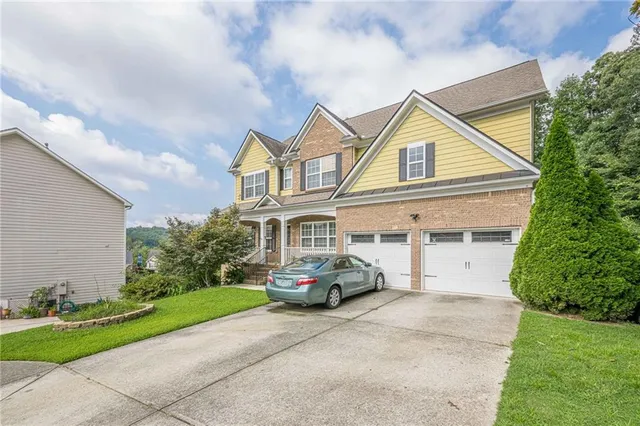 a car parked in front of white house