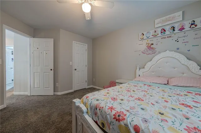 a spacious bedroom with a bed and a window