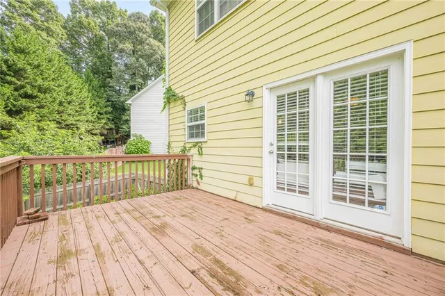 a balcony with wooden floor and city view