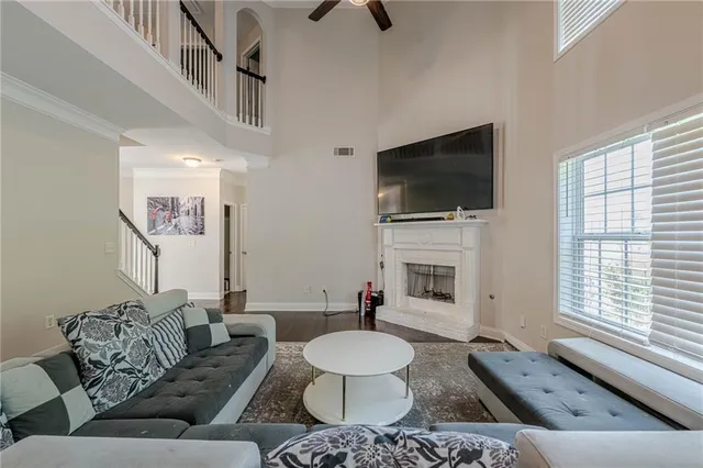 a living room with furniture a flat screen tv and a fireplace