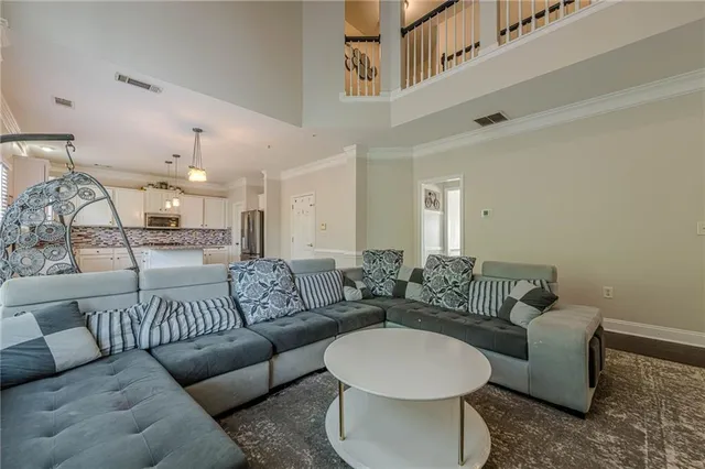 a living room with furniture and a large mirror