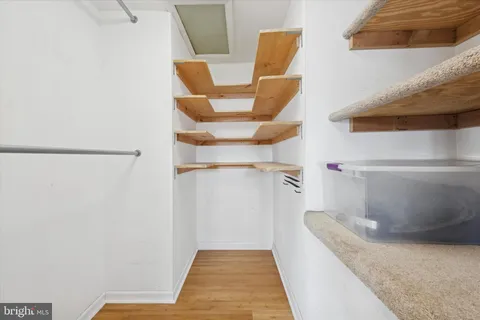 a view of a hallway with wooden floor and entryway