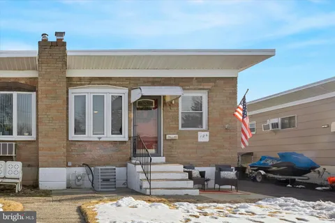 a front view of a house with cars