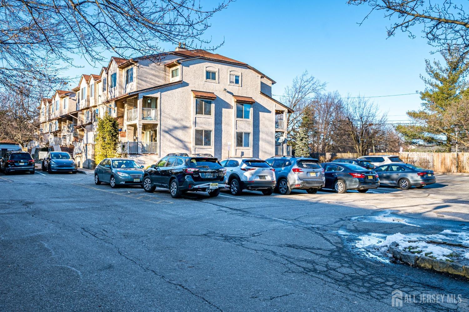 409 North Lafayette Road, Unit 409 Metuchen, NJ 08840 - Photo 1 of 24 a front view of a building with cars parked