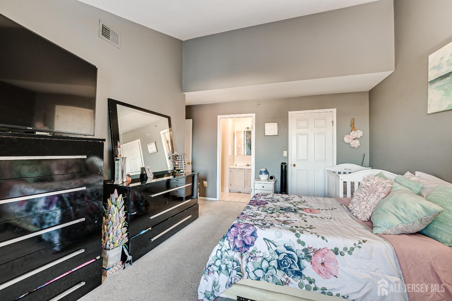409 North Lafayette Road, Unit 409 Metuchen, NJ 08840 - Photo 18 of 24 a bedroom with a bed and a television
