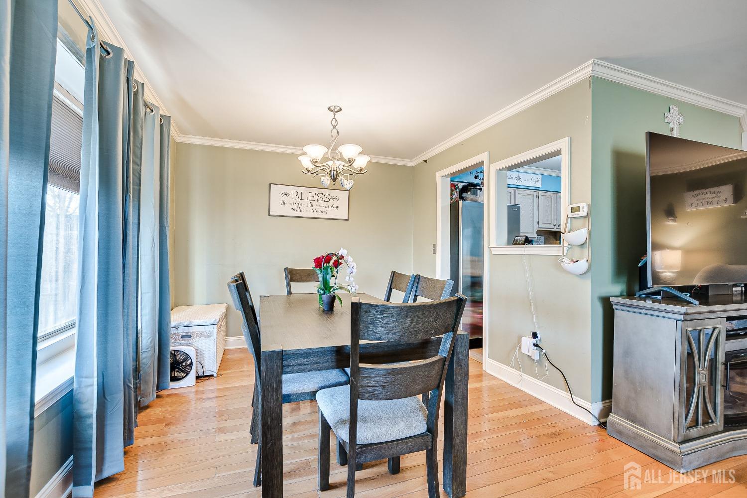 409 North Lafayette Road, Unit 409 Metuchen, NJ 08840 - Photo 7 of 24 a view of a dining room with furniture and chandelier