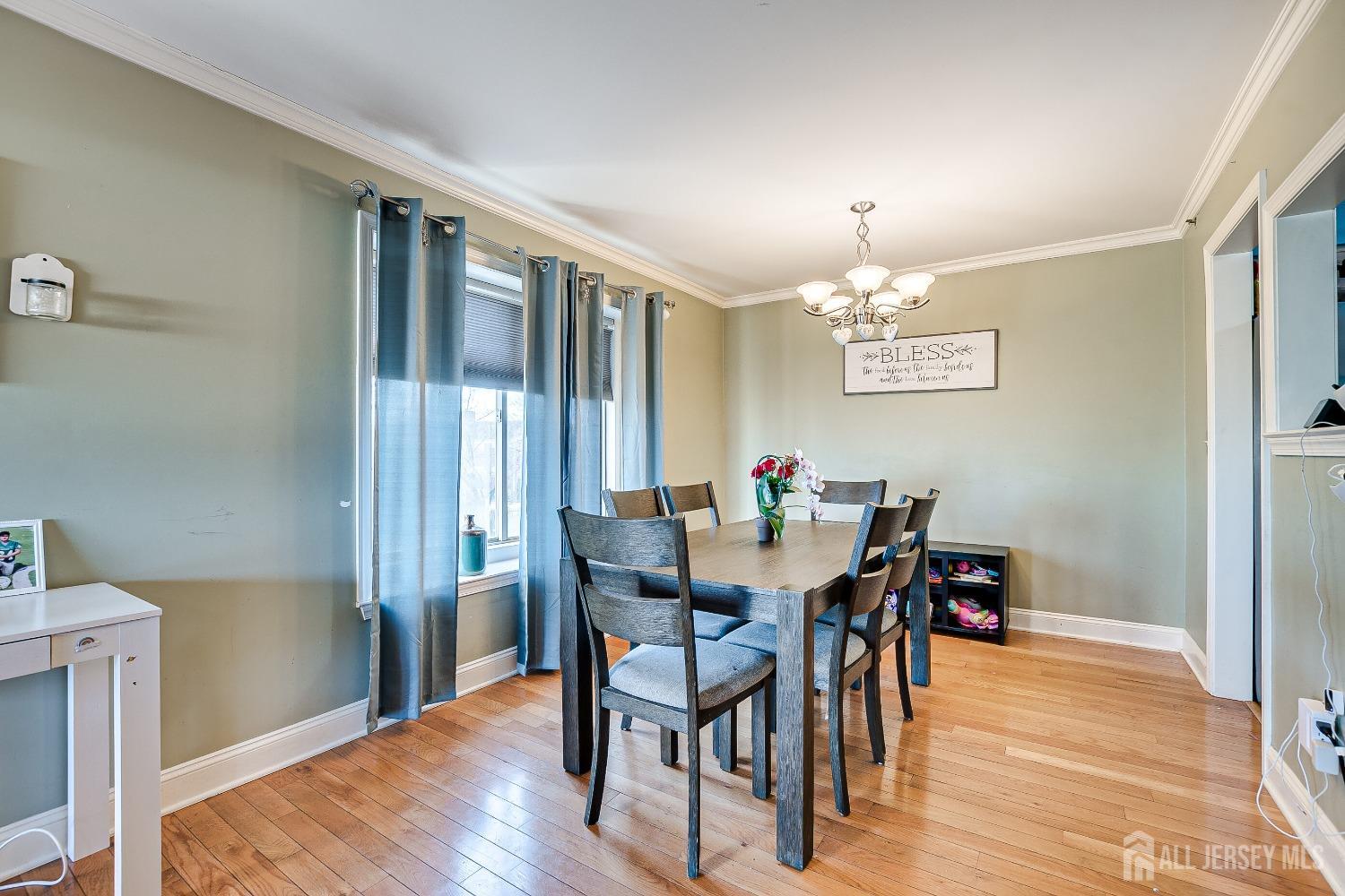 409 North Lafayette Road, Unit 409 Metuchen, NJ 08840 - Photo 8 of 24 a view of a dining room with furniture and wooden floor