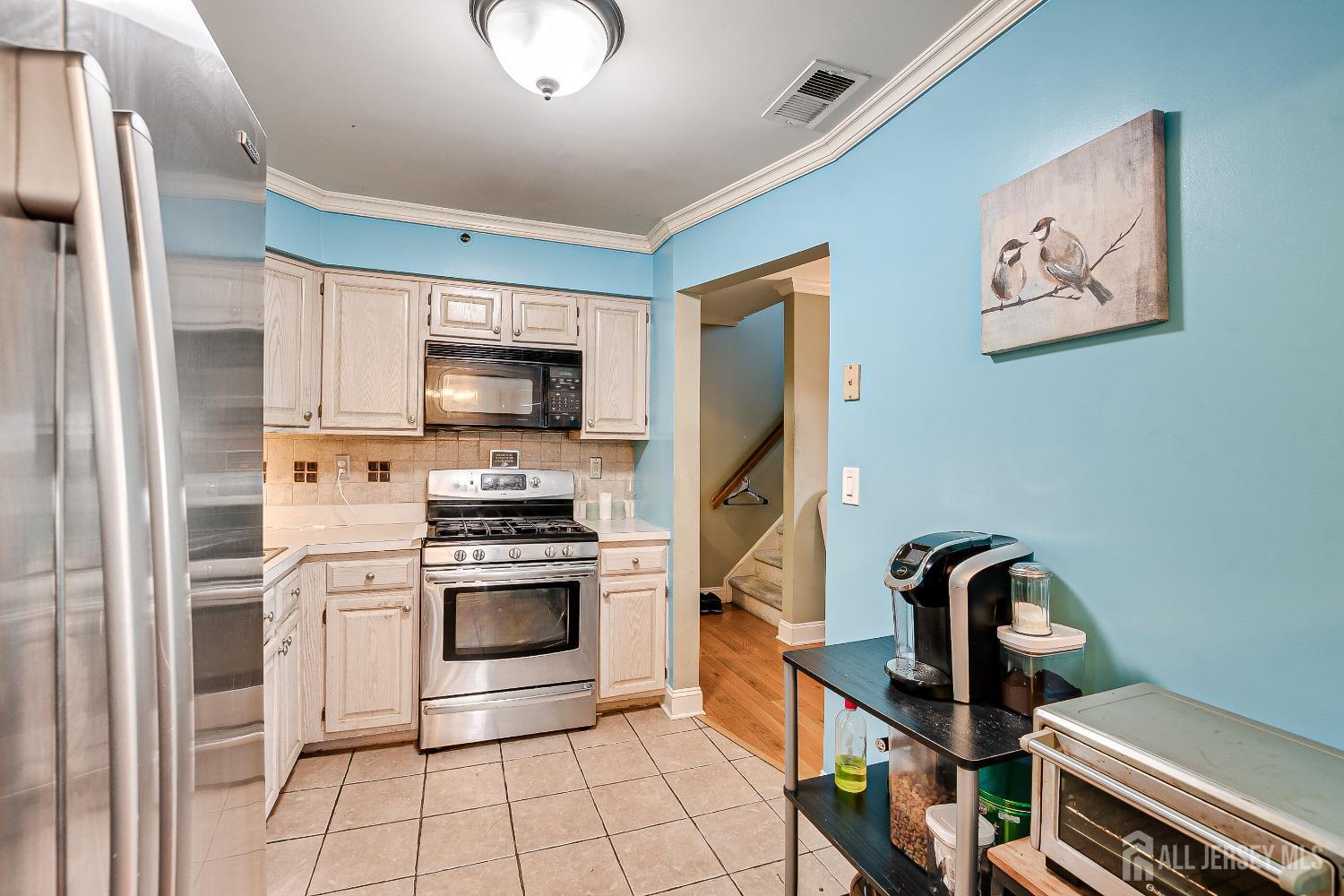 409 North Lafayette Road, Unit 409 Metuchen, NJ 08840 - Photo 9 of 24 a kitchen with a stove and a refrigerator