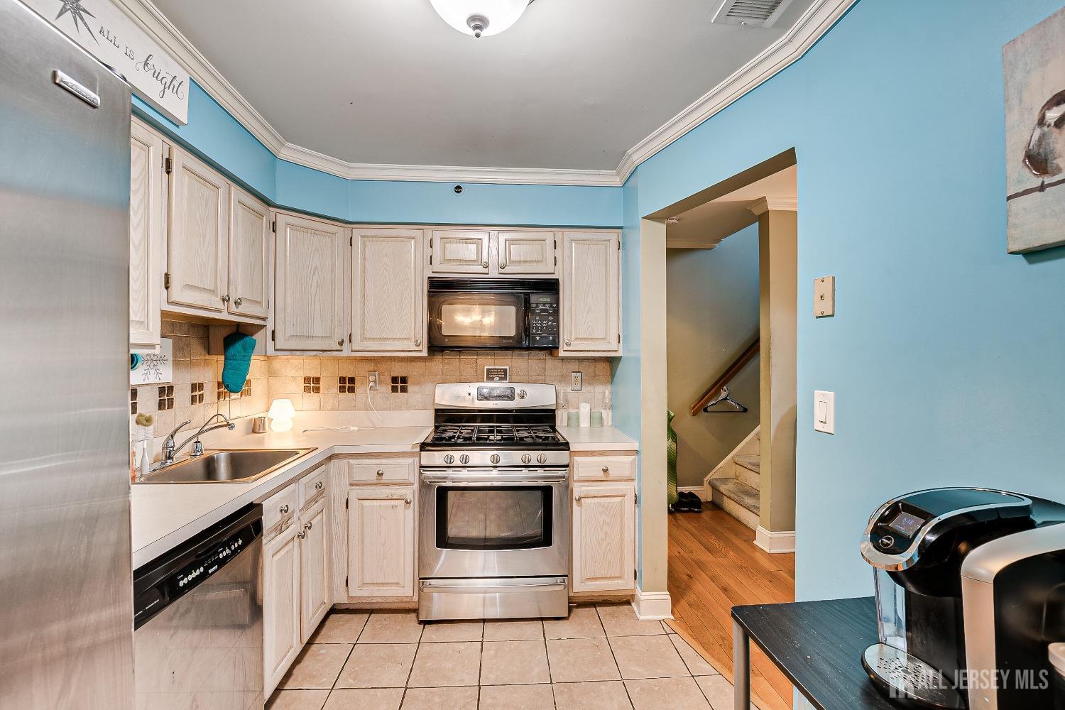 409 North Lafayette Road, Unit 409 Metuchen, NJ 08840 - Photo 10 of 24 a kitchen with a stove a sink and a microwave