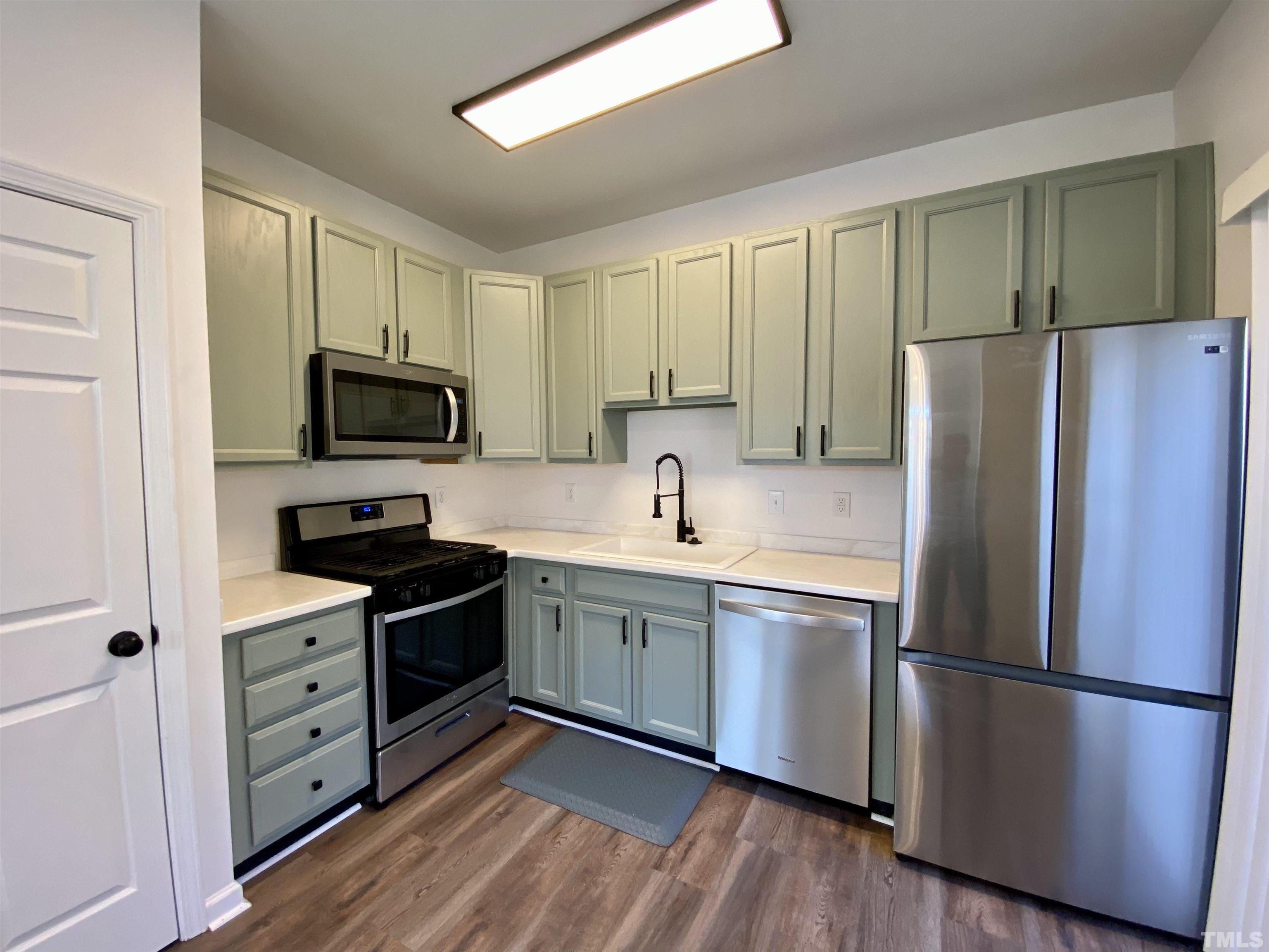 2225 Raven Road, Unit 108 Raleigh, NC 27614 - Photo 14 of 26 a kitchen with stainless steel appliances a refrigerator sink and microwave