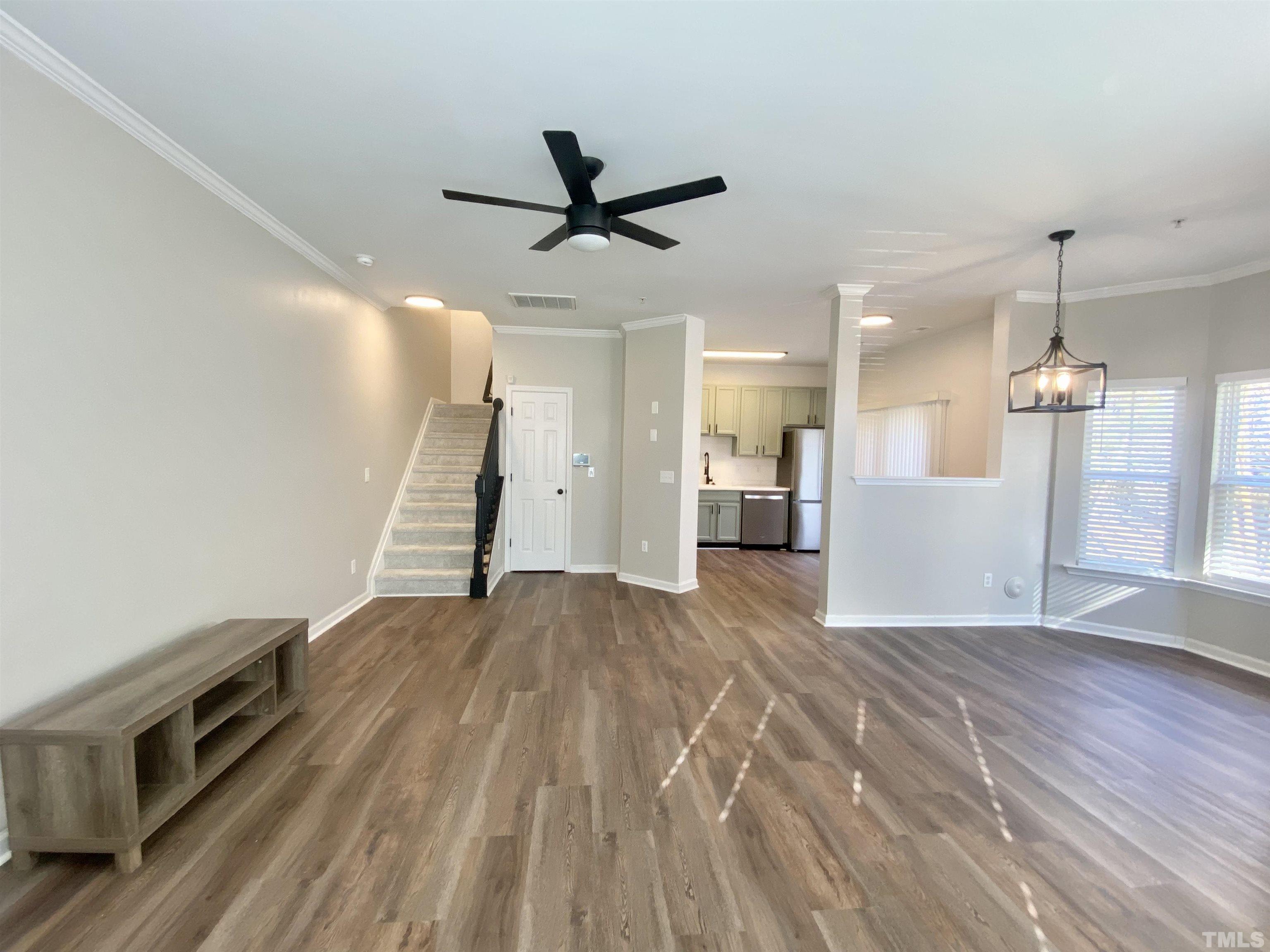 2225 Raven Road, Unit 108 Raleigh, NC 27614 - Photo 3 of 26 a view of a big room with wooden floor and windows