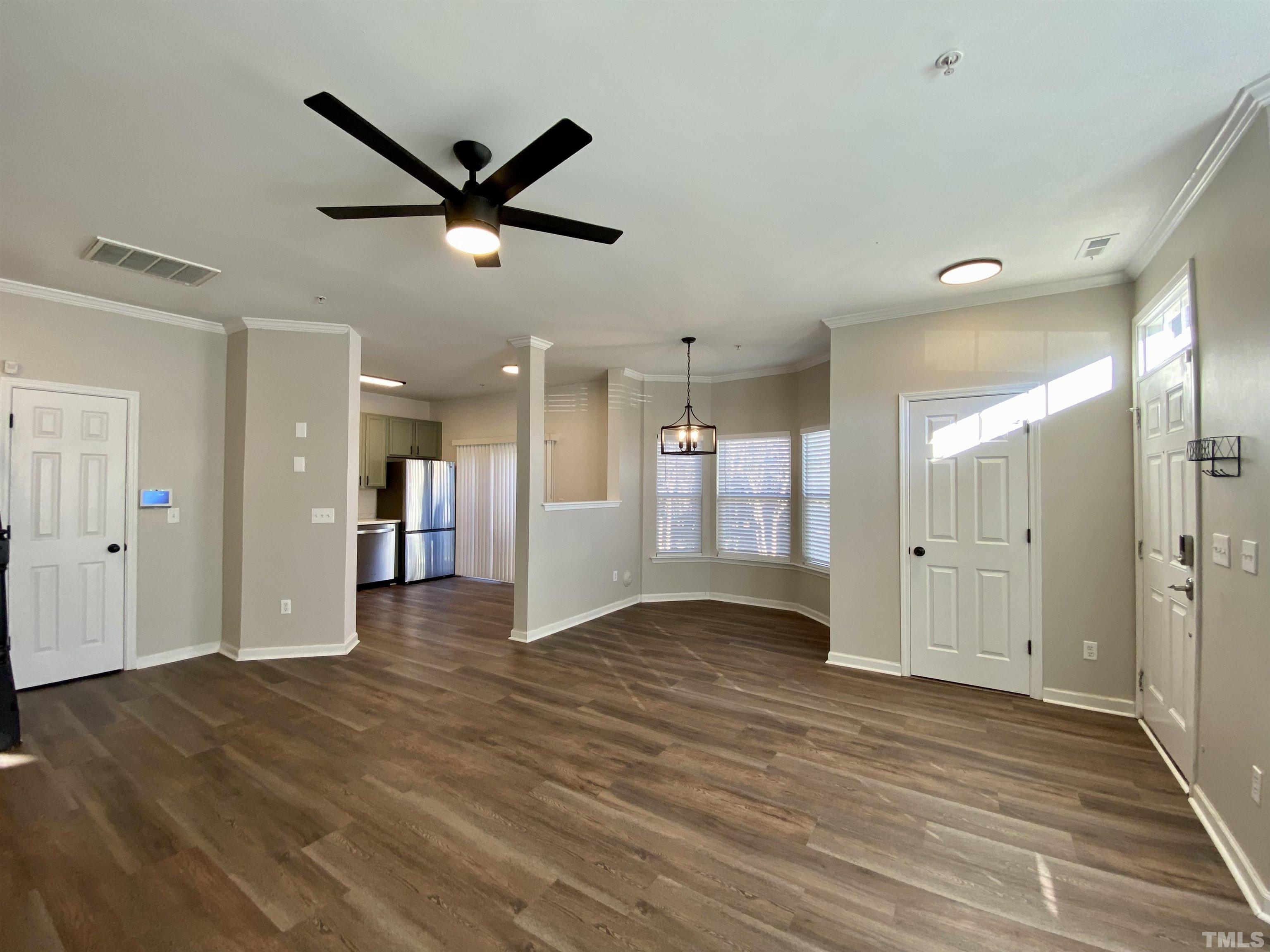 2225 Raven Road, Unit 108 Raleigh, NC 27614 - Photo 5 of 26 a view of a livingroom with a ceiling fan wooden floor and a ceiling fan