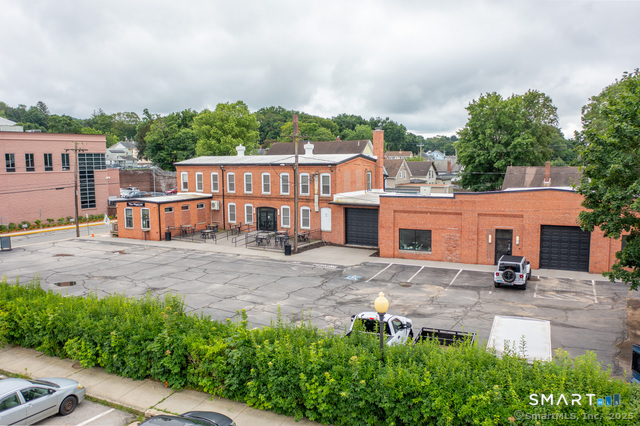 an aerial view of a house with a yard