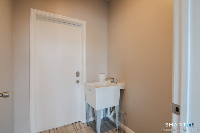 113 School Street Killingly, CT 06239 - Photo 11 of 33 a bathroom with a sink a mirror and a toilet